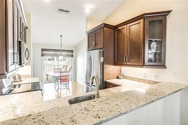 a bathroom with a granite countertop sink and a large mirror