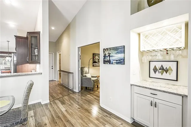 a view of a living room with furniture wooden floor and a large window