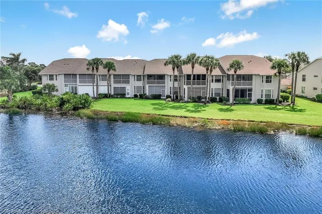 a view of a big house with a big yard and potted plants