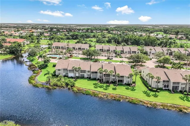 an aerial view of a house with a garden and lake view