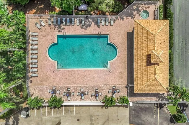 an aerial view of a house with outdoor space and a swimming pool
