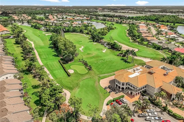 an aerial view of a residential houses with outdoor space and river view
