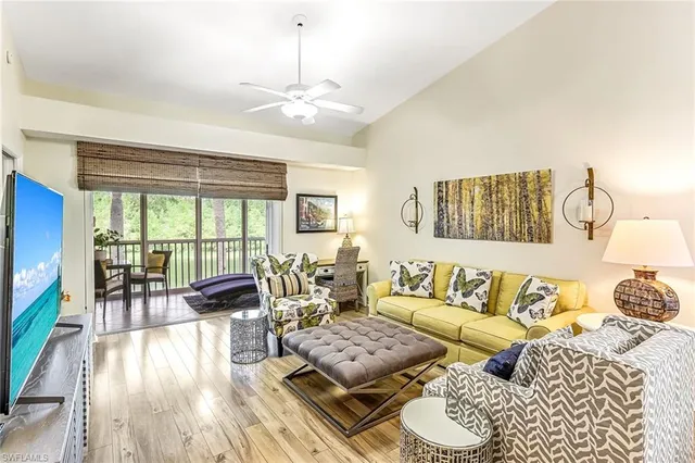 a living room with furniture and a floor to ceiling window