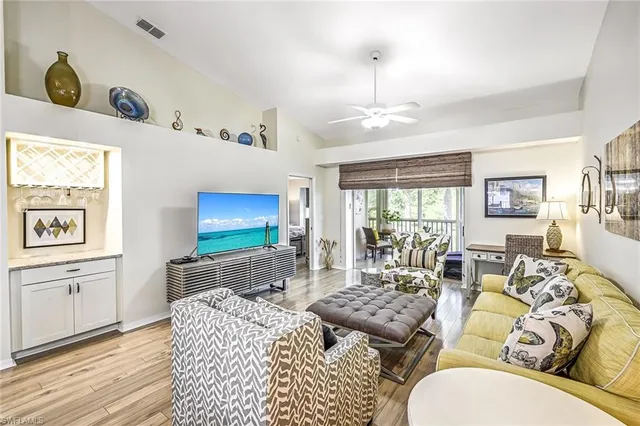 a living room with furniture a large window and a table