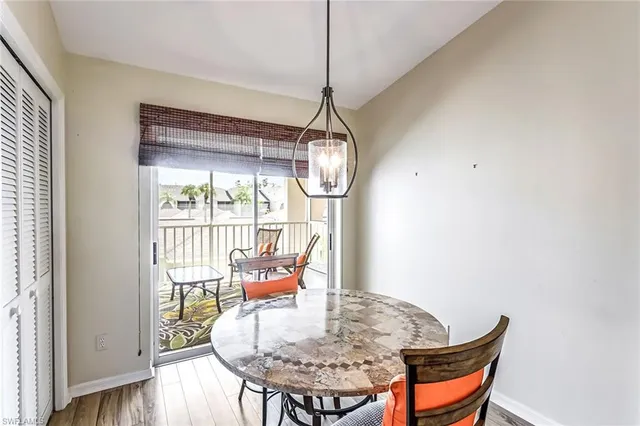 a dining room with furniture and wooden floor