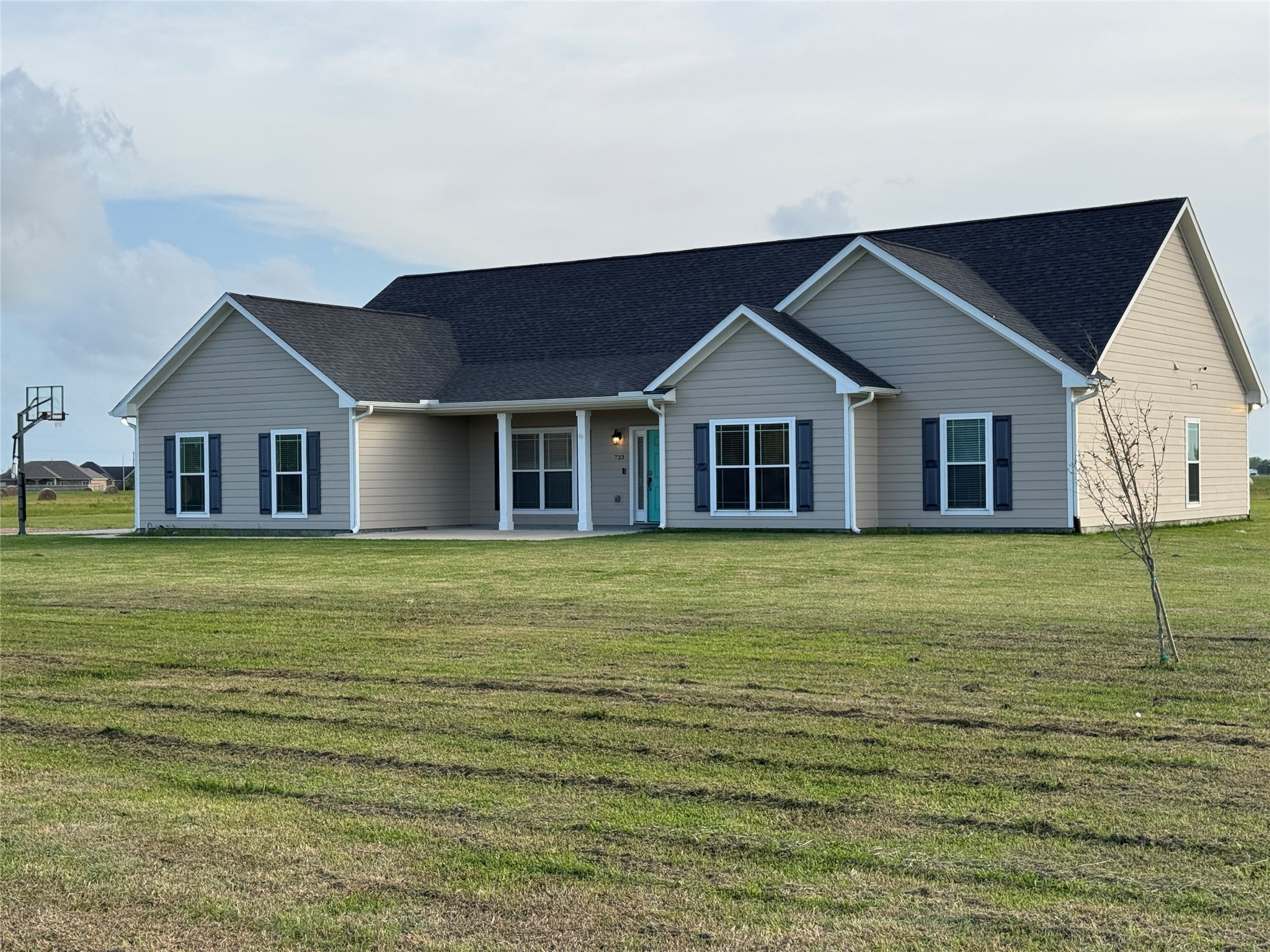 a front view of a house with a garden