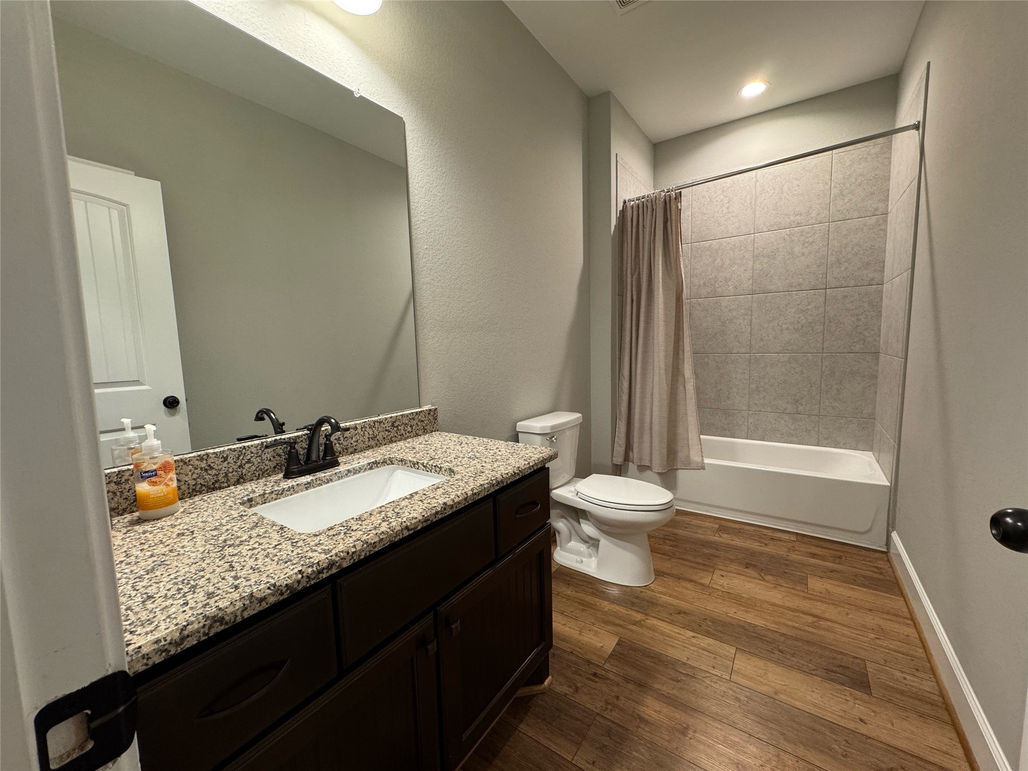 723 Sandy Corner Road El Campo, TX 77437 - Photo 17 of 20 a bathroom with a granite countertop sink toilet and shower