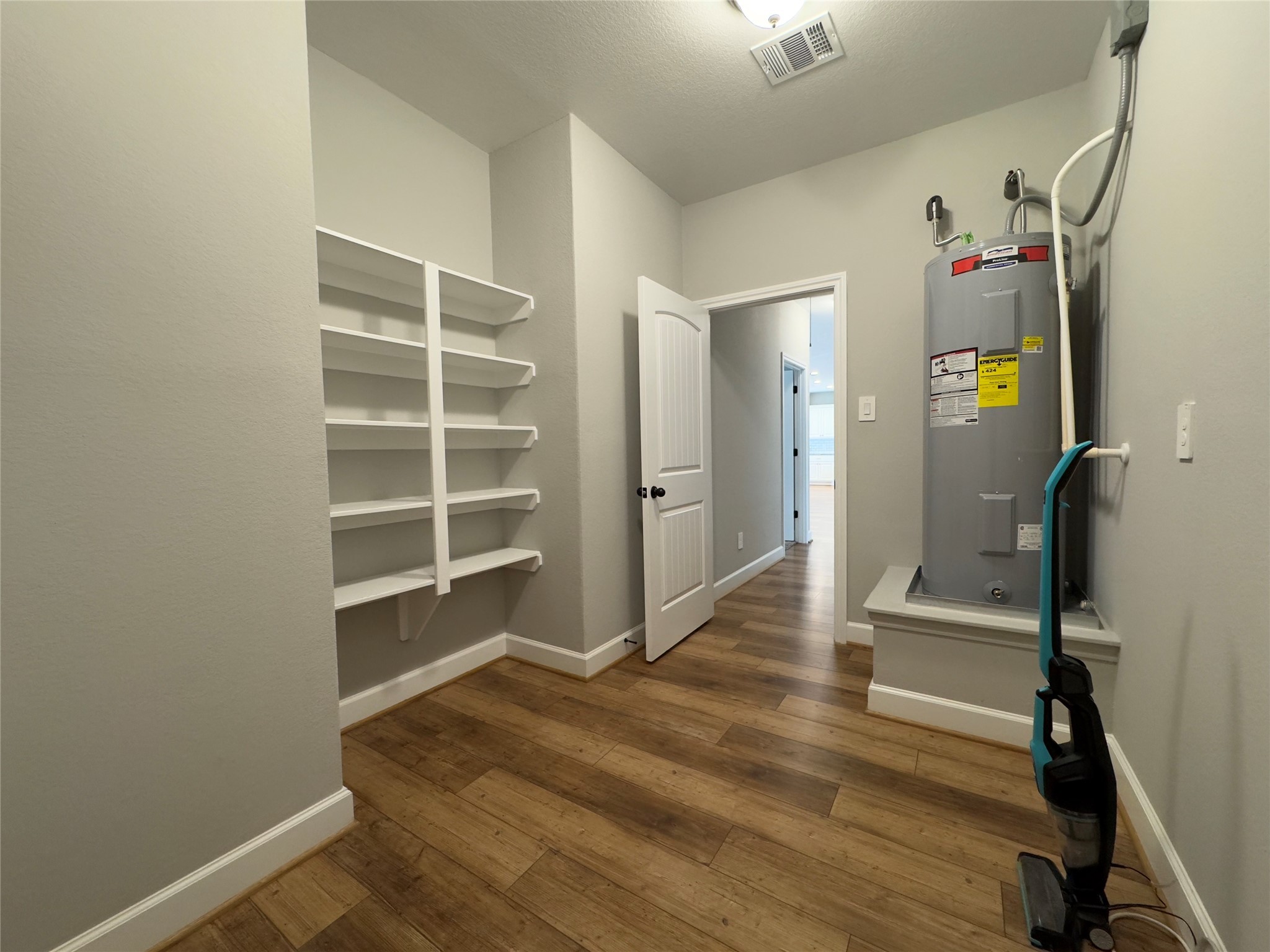 723 Sandy Corner Road El Campo, TX 77437 - Photo 18 of 20 a view of a hallway with wooden floor and closet