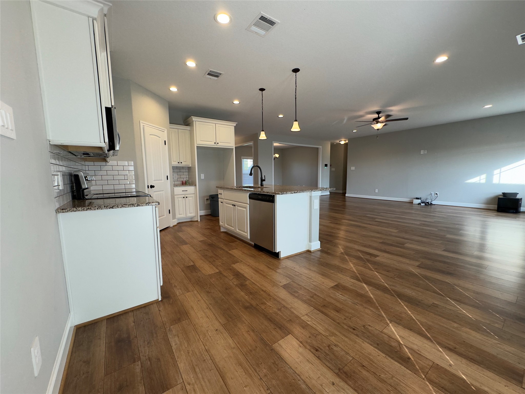 723 Sandy Corner Road El Campo, TX 77437 - Photo 9 of 20 a view of kitchen with cabinets and wooden floor