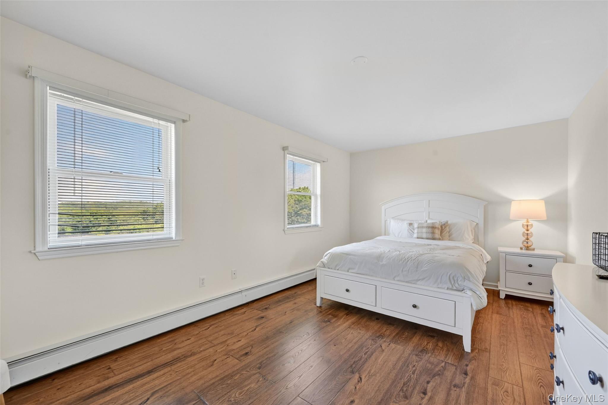 19 Bull Mine Road Chester, NY 10918 - Photo 30 of 42 Bedroom featuring durable wood-finish flooring, two window openings, neutral wall paint, and white trim