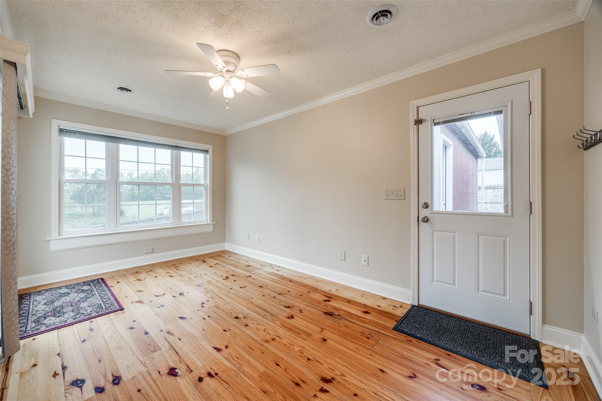 1545 Wimbleton Woods Drive Fort Mill, SC 29708 - Photo 17 of 42 a view of an empty room with a window and wooden floor