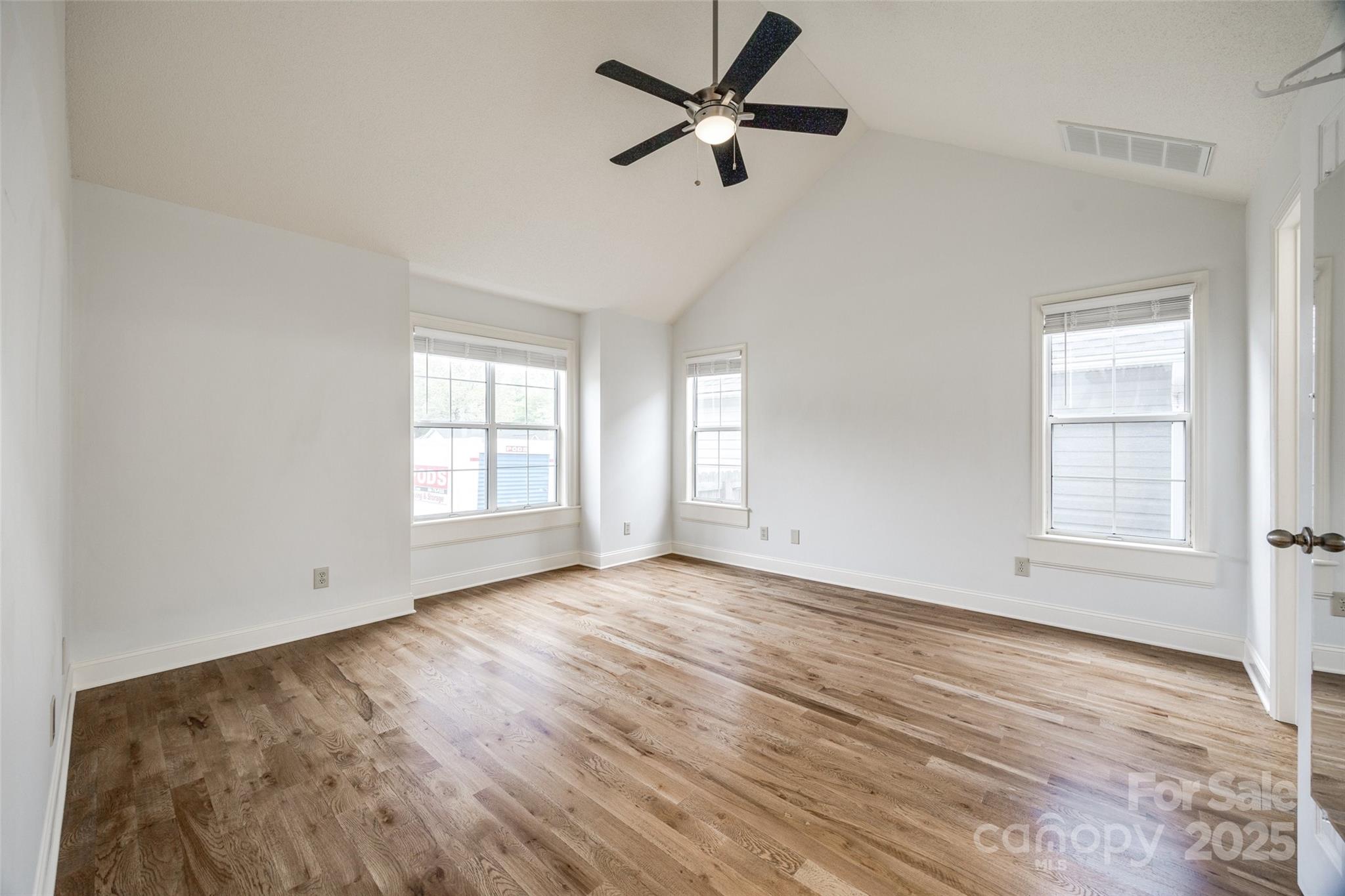 1545 Wimbleton Woods Drive Fort Mill, SC 29708 - Photo 18 of 42 an empty room with wooden floor ceiling fan and windows