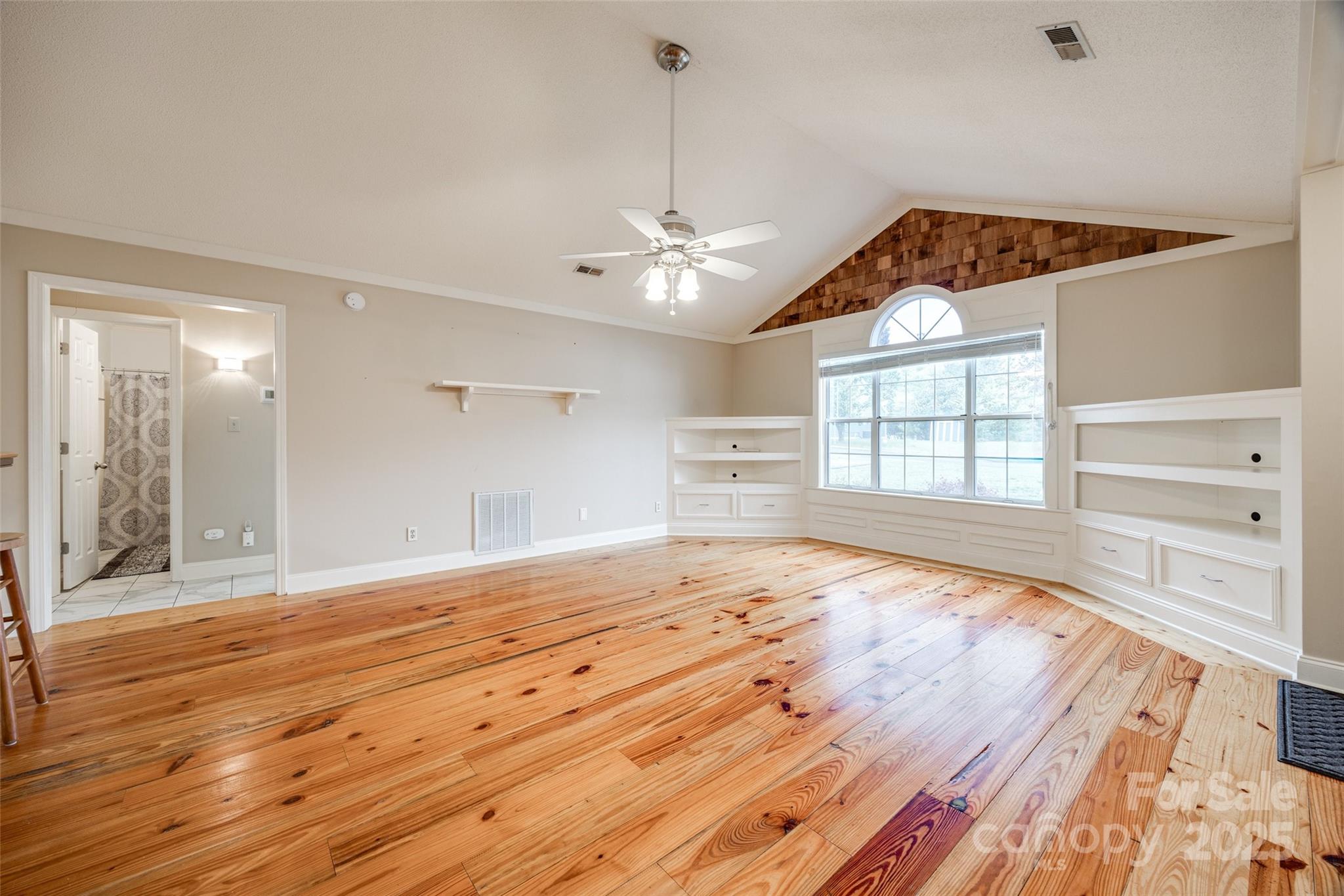 1545 Wimbleton Woods Drive Fort Mill, SC 29708 - Photo 7 of 42 a view of an empty room with a window and wooden floor
