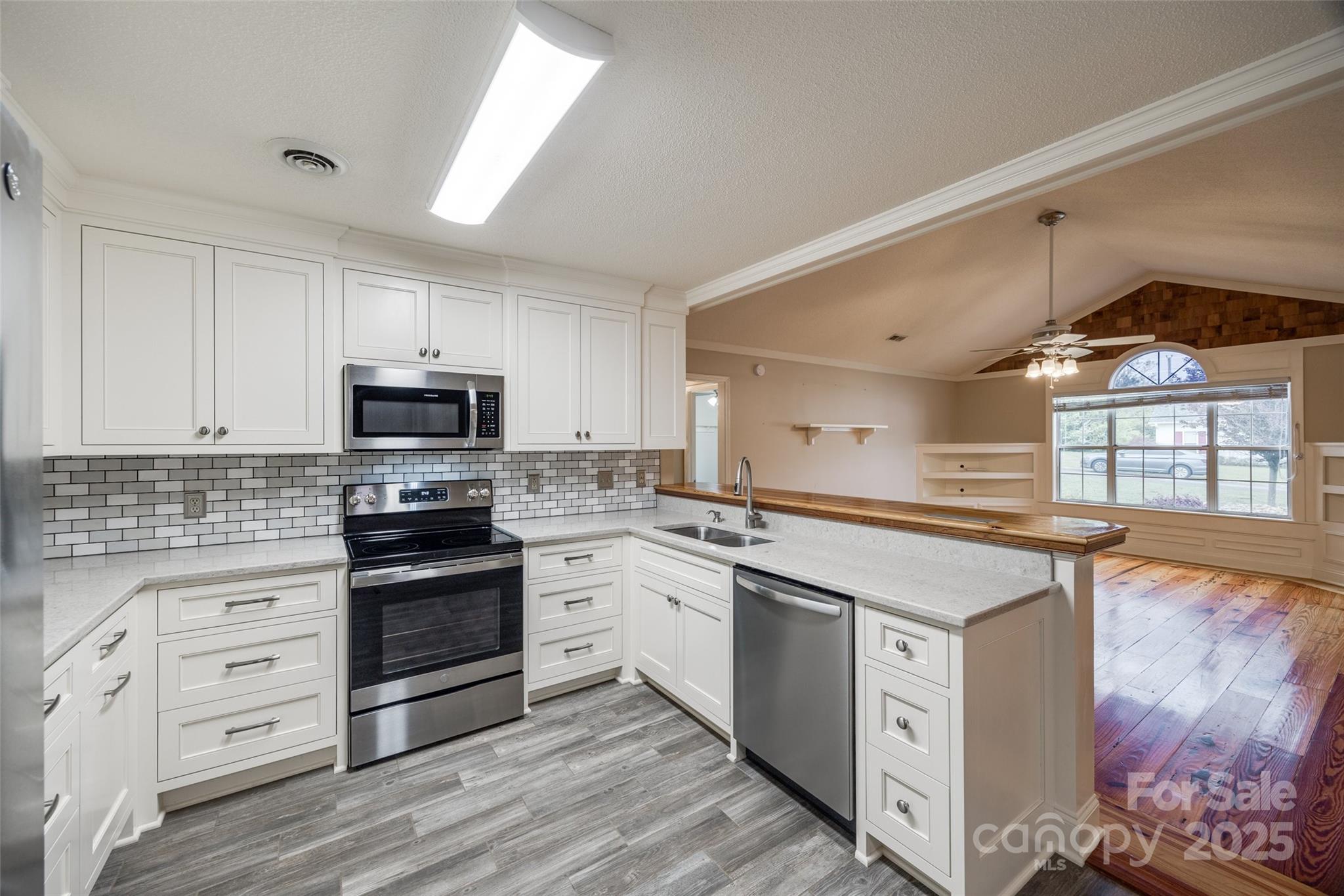 1545 Wimbleton Woods Drive Fort Mill, SC 29708 - Photo 9 of 42 a kitchen with granite countertop a sink cabinets stainless steel appliances and a window