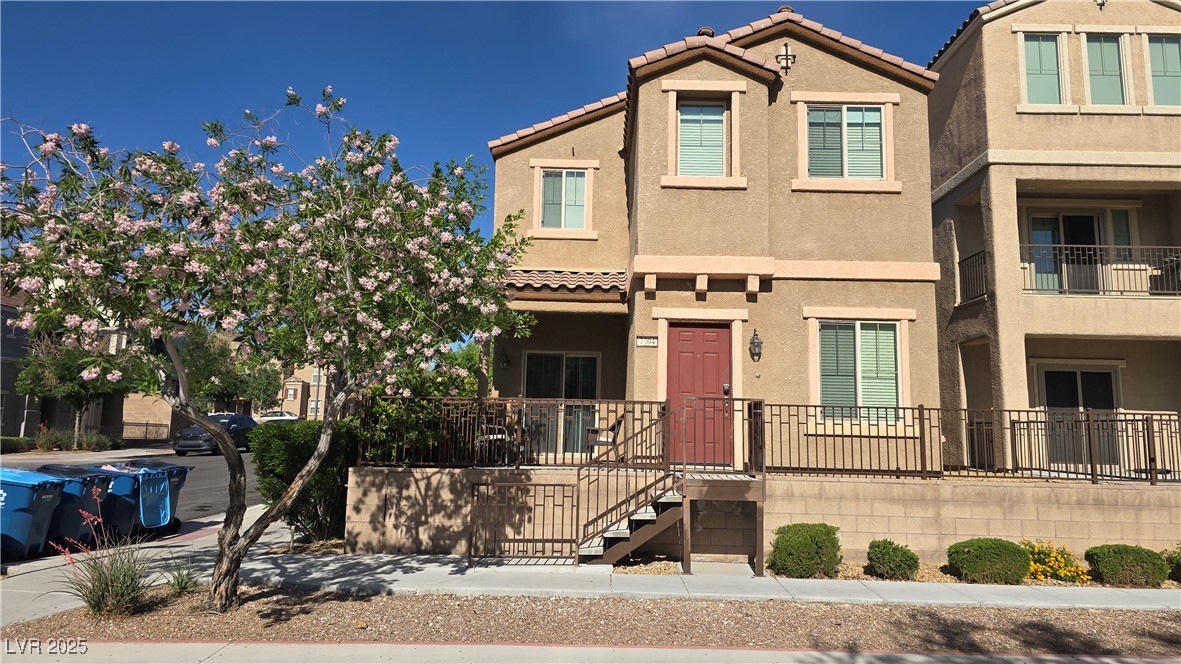 Townhome / multi-family property featuring stucco siding and a tile roof
