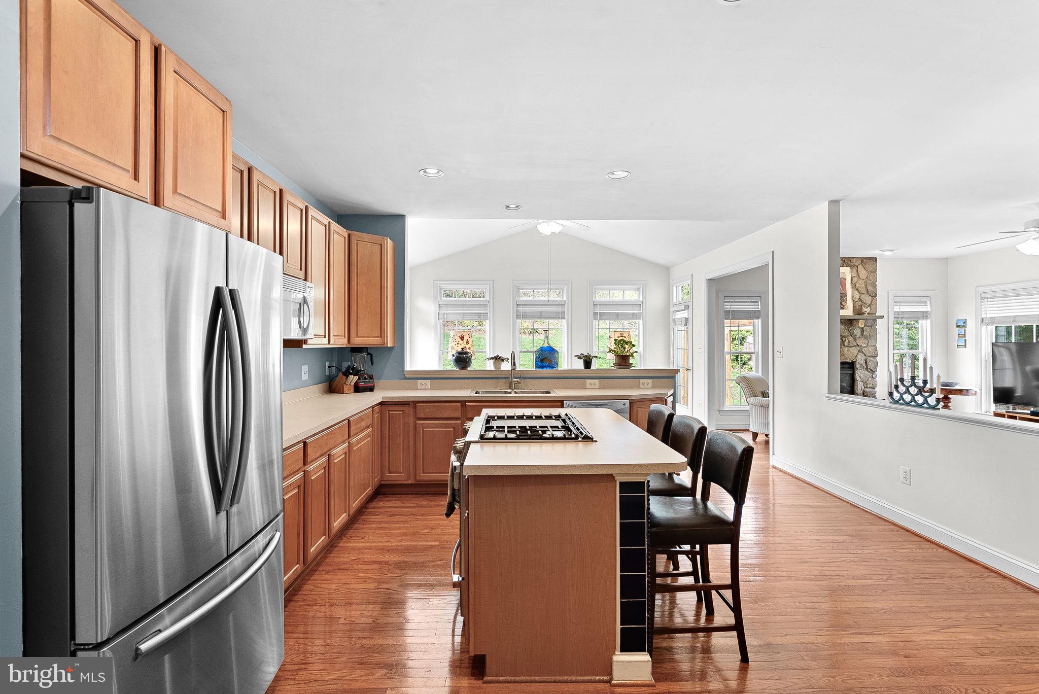 1921 Harvest Drive Winchester, VA 22601 - Photo 18 of 44 a kitchen with stainless steel appliances a table chairs and a refrigerator