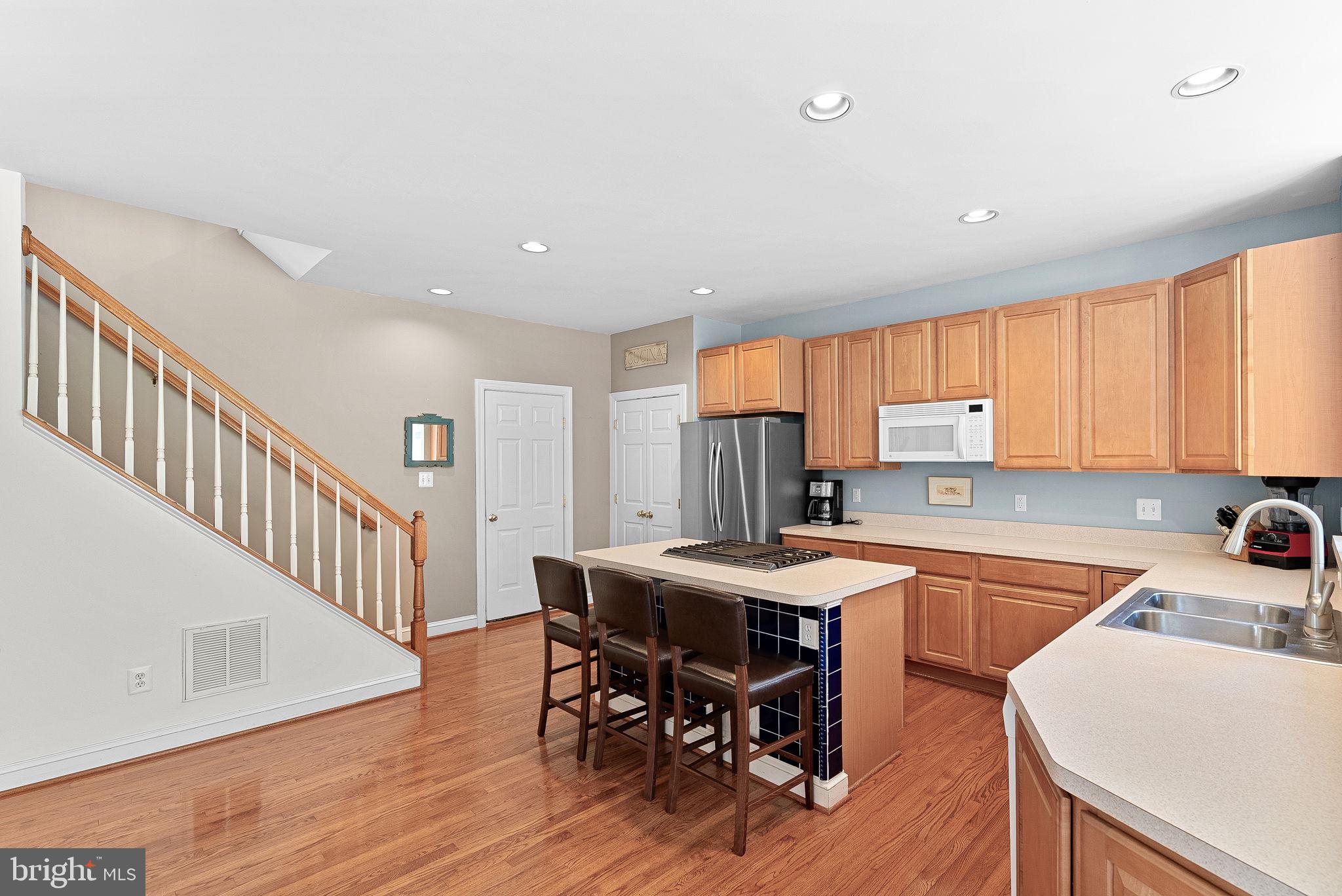 1921 Harvest Drive Winchester, VA 22601 - Photo 20 of 44 a kitchen with a dining table chairs and white cabinets