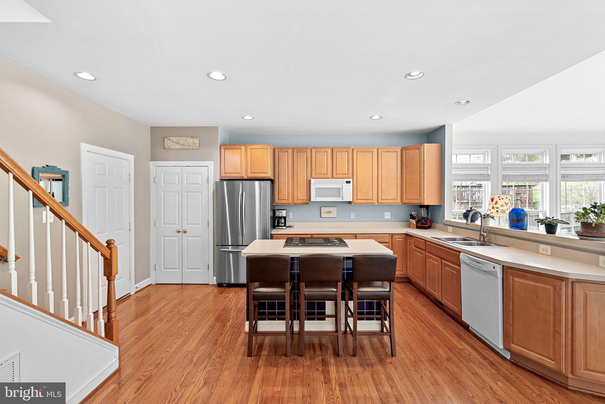 1921 Harvest Drive Winchester, VA 22601 - Photo 21 of 44 a kitchen with stainless steel appliances a dining table chairs and wooden floors
