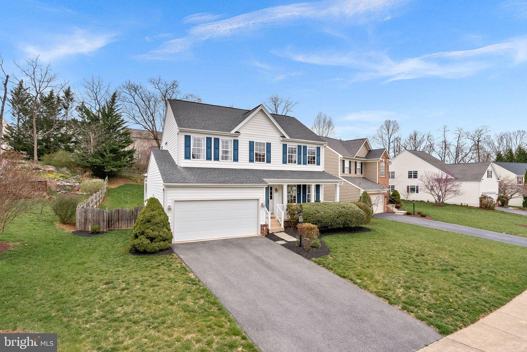1921 Harvest Drive Winchester, VA 22601 - Photo 4 of 44 a front view of a house with a garden and yard