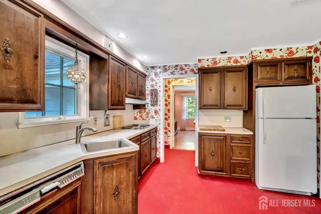 a kitchen with a sink window and cabinets