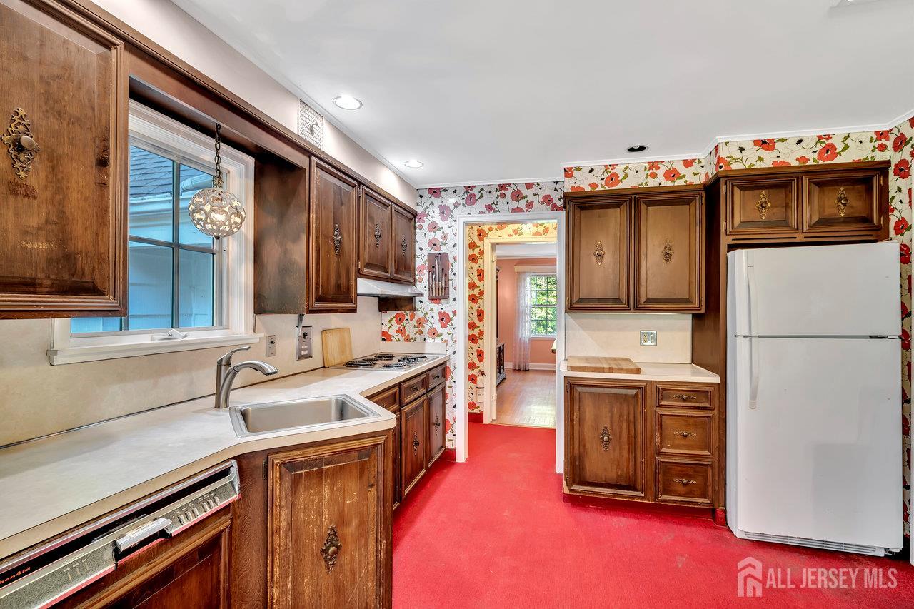 1010 River Road Piscataway, NJ 08854 - Photo 16 of 47 a kitchen with granite countertop a sink stove and refrigerator