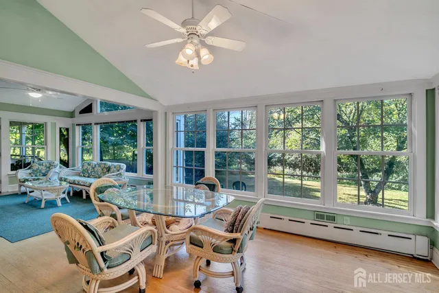 a living room with furniture and a floor to ceiling window