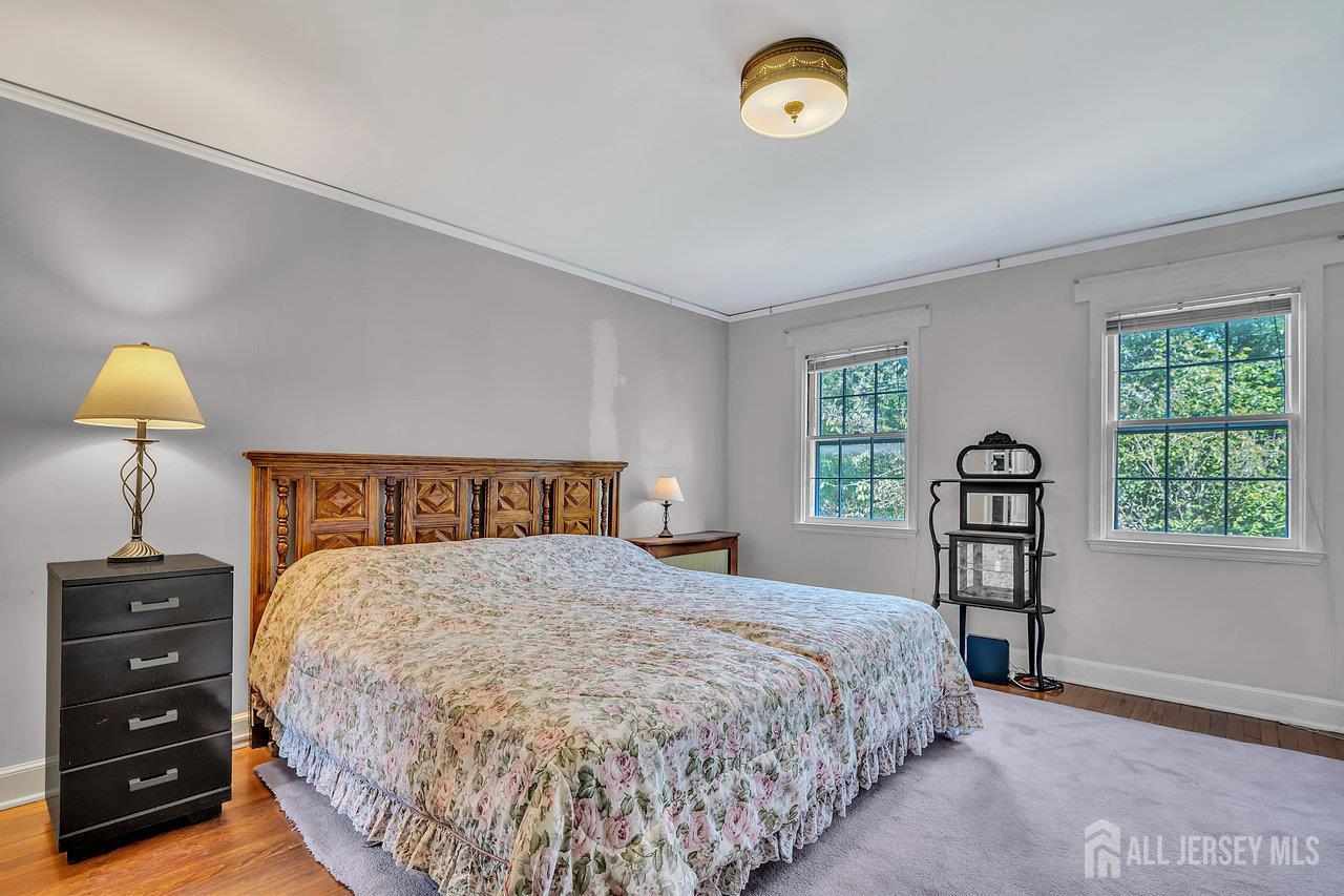 1010 River Road Piscataway, NJ 08854 - Photo 33 of 47 a bedroom with a bed and a lamp