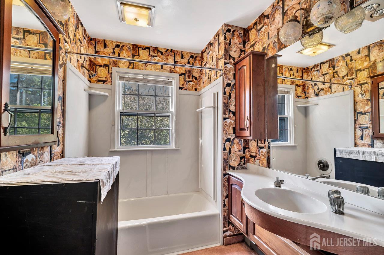 1010 River Road Piscataway, NJ 08854 - Photo 34 of 47 a bathroom with a tub sink and mirror