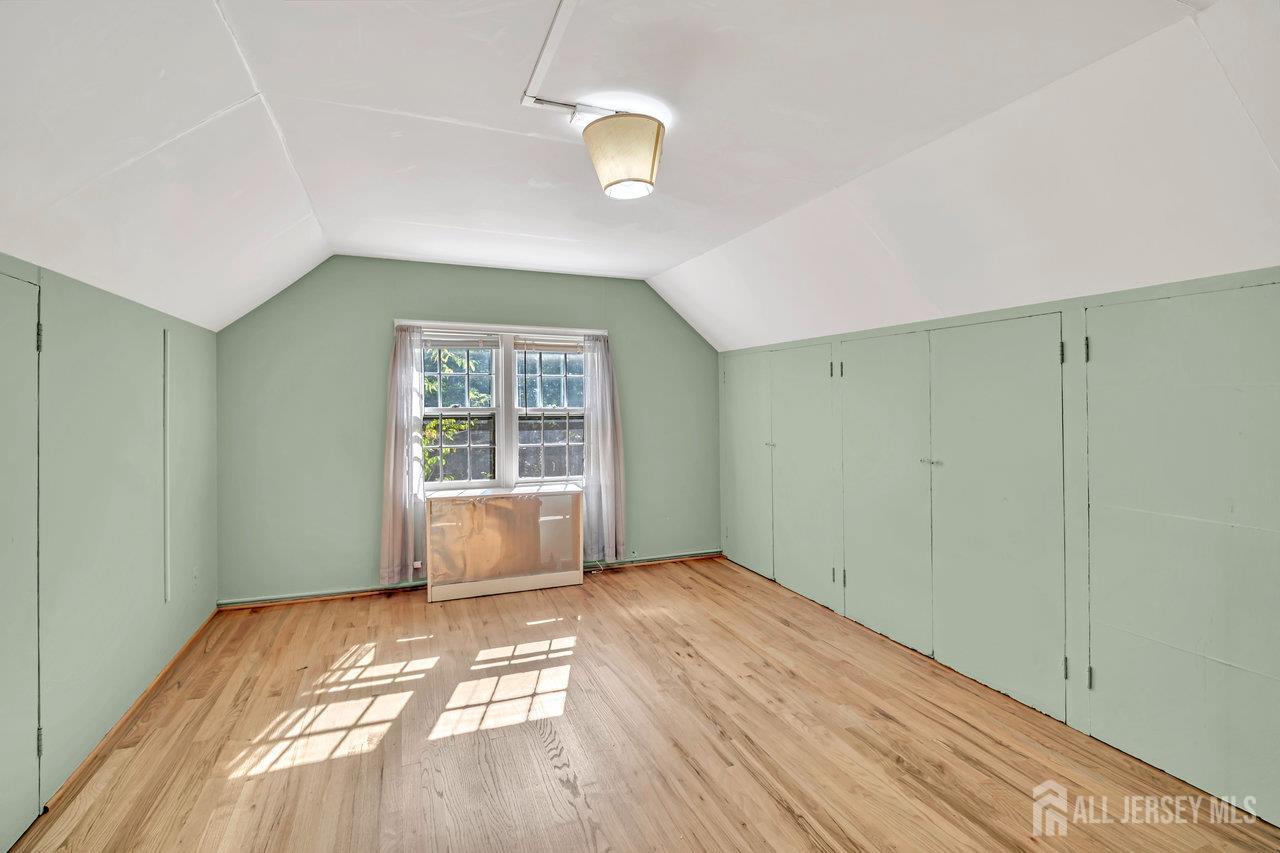1010 River Road Piscataway, NJ 08854 - Photo 36 of 47 a view of an empty room with wooden floor and a window
