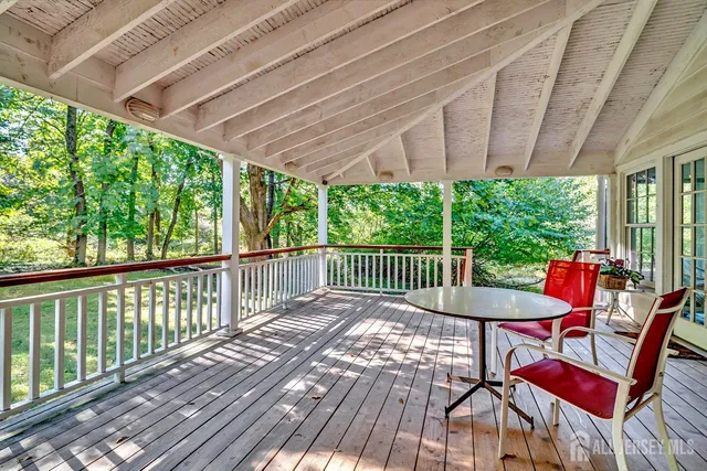 a view of a house with a yard balcony and sitting area
