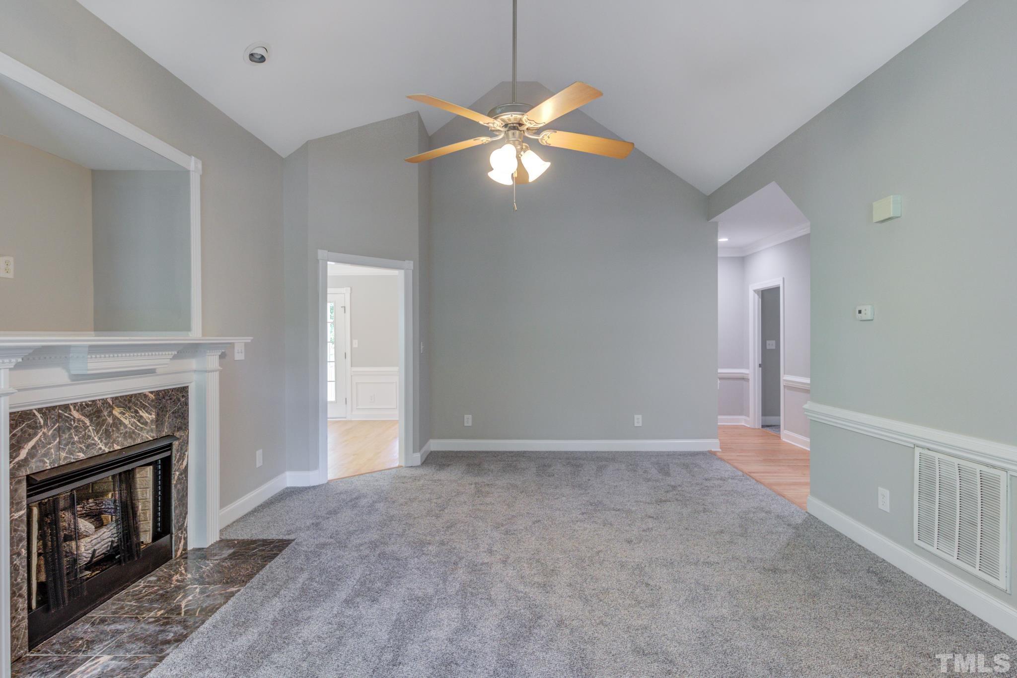 4425 Irene Way Raleigh, NC 27603 - Photo 5 of 28 a view of an empty room with window and fireplace