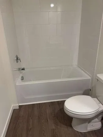a bathroom with a toilet and a bath tub