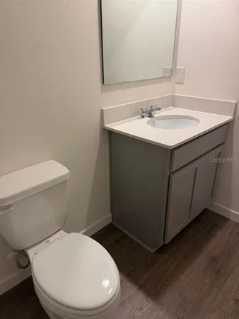 a white toilet sitting next to a bathroom sink