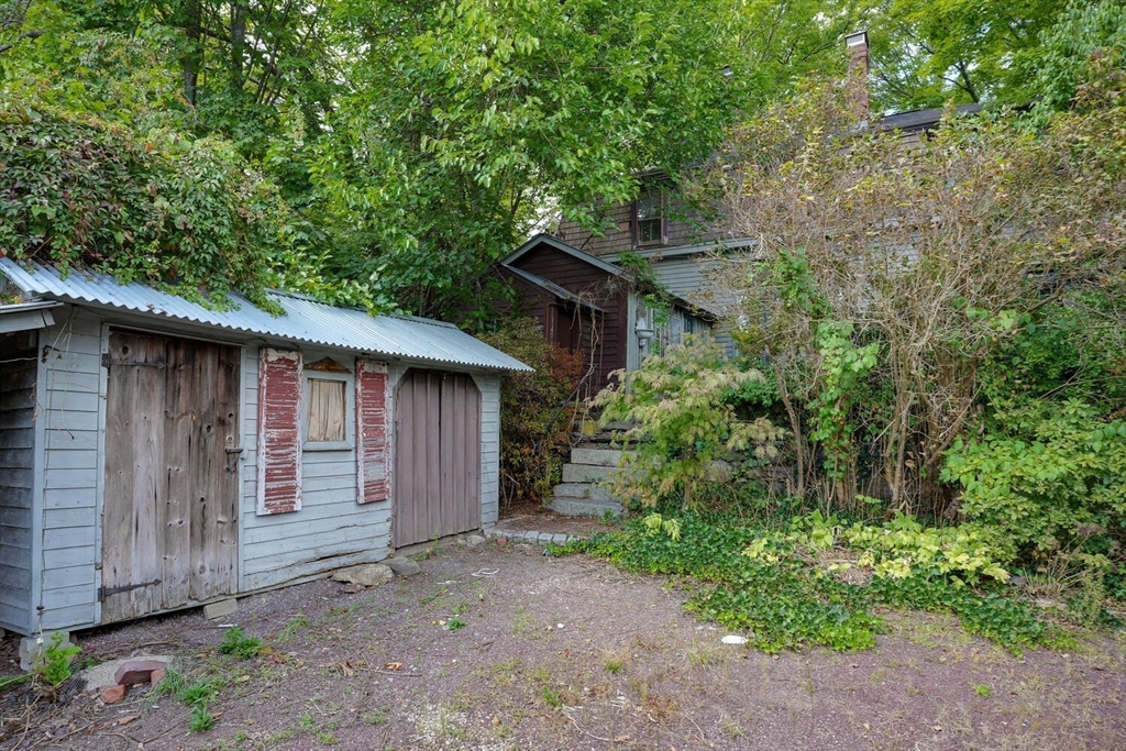 15 Crescent Street Stow, MA 01775 - Photo 7 of 21 a backyard of a house with large trees and wooden fence