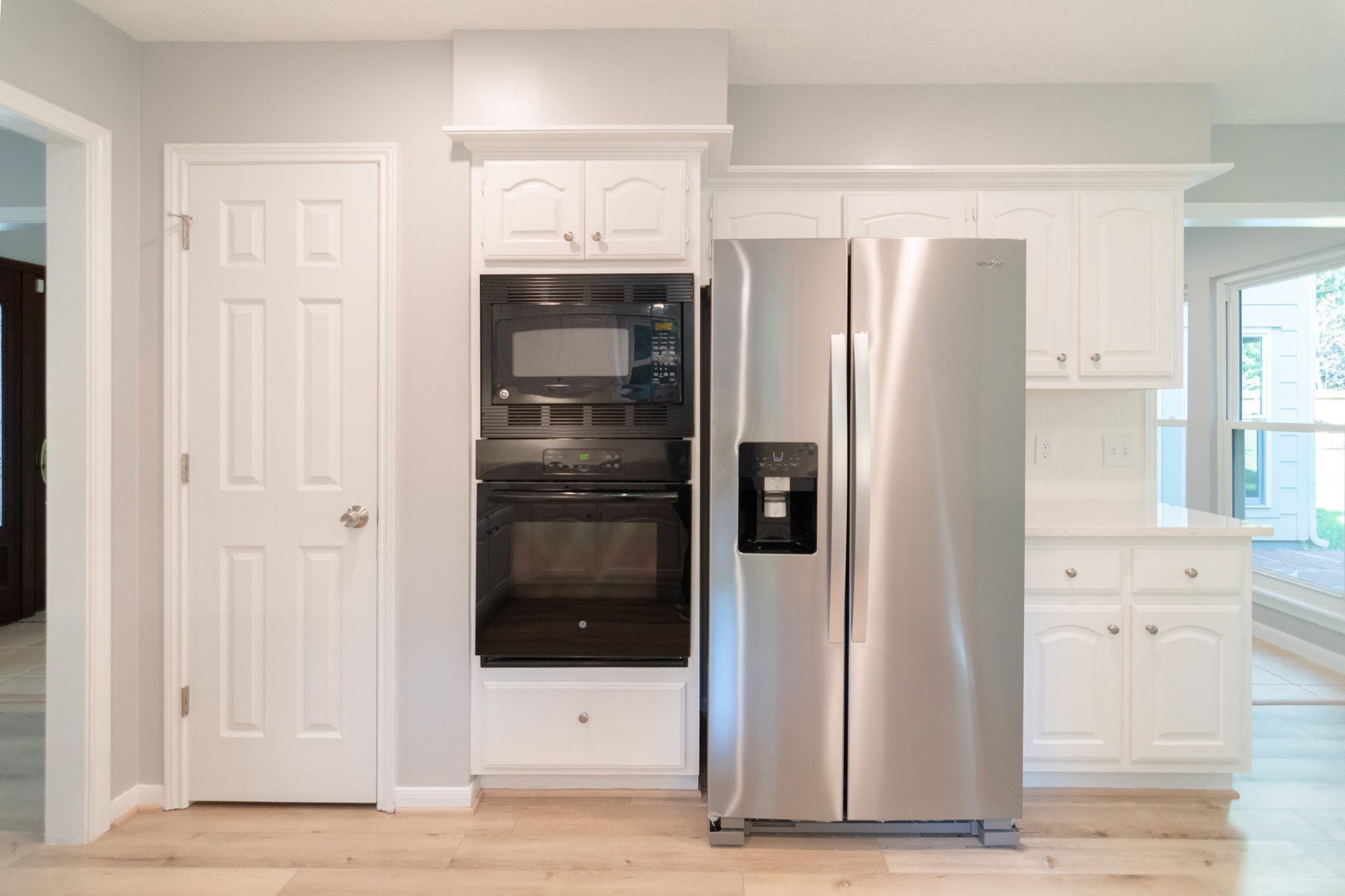 10 Coralvine Court Spring, TX 77380 - Photo 14 of 34 Stainless steel side-by-side refrigerator and built-in oven and microwave.
