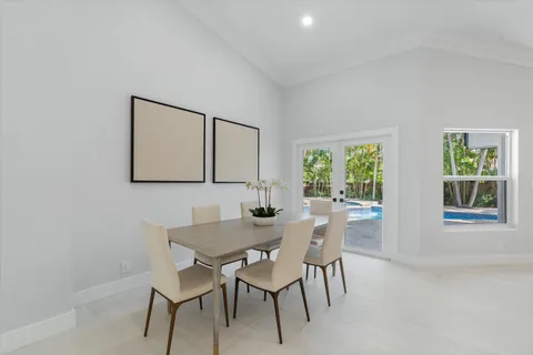 a view of a dining room with furniture and a window