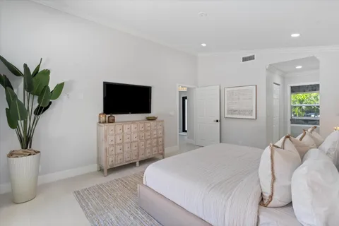 a bedroom with a bed and a flat screen tv