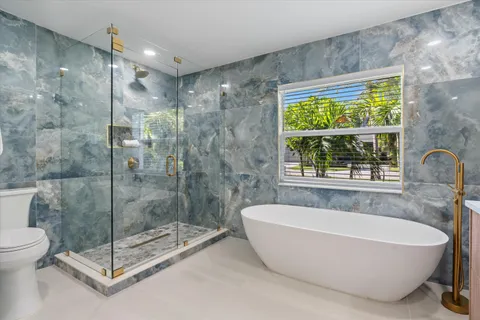a bathroom with a bathtub and shower