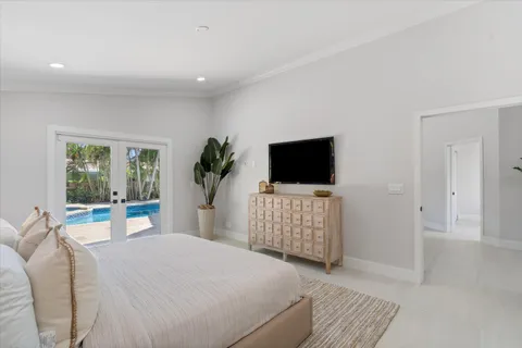 a bedroom with a bed and a flat screen tv