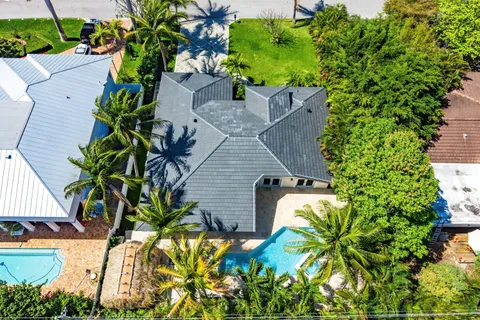 an aerial view of a house with a yard and garden