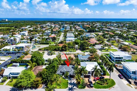 an aerial view of residential houses with outdoor space and trees all around