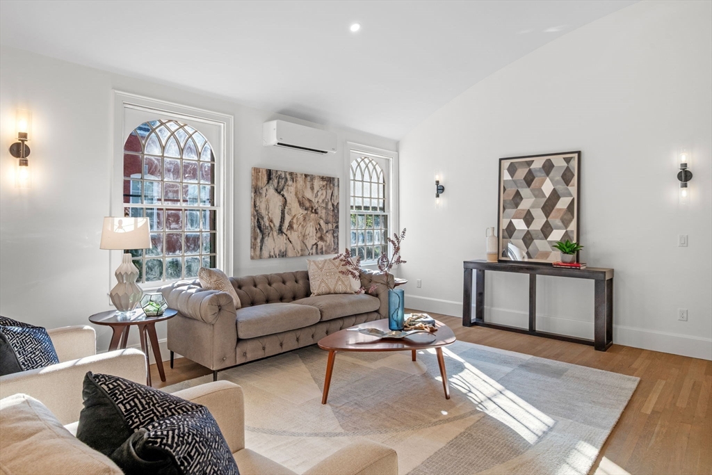 134 Elm Street, Unit 134 Marblehead, MA 01945 - Photo 12 of 38 a living room with furniture a rug and a window