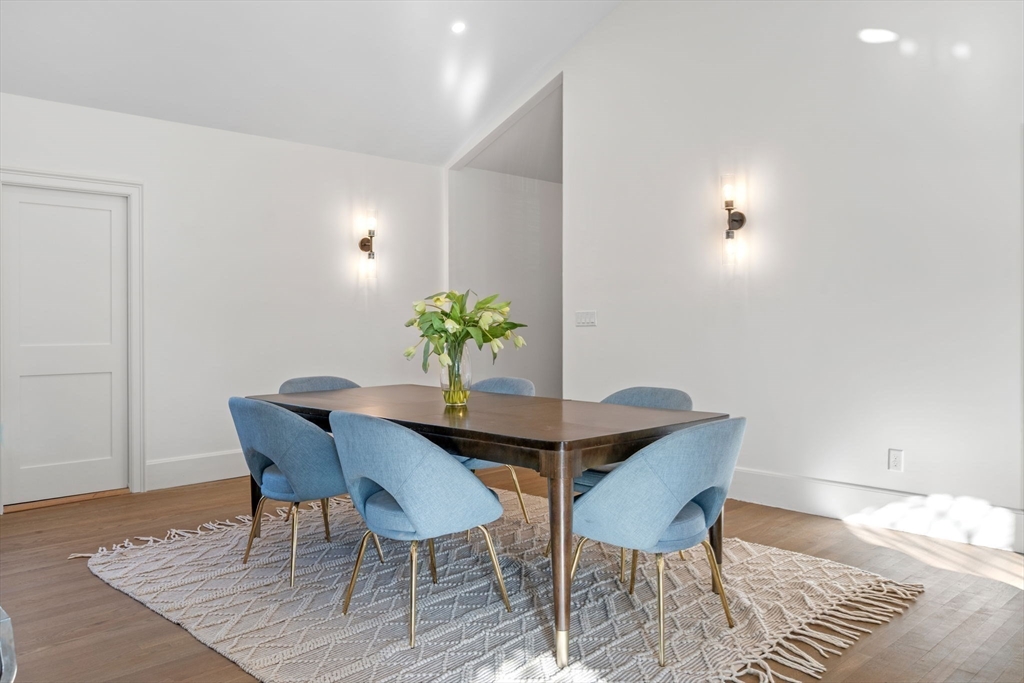 134 Elm Street, Unit 134 Marblehead, MA 01945 - Photo 13 of 38 a dining room with furniture and wooden floor