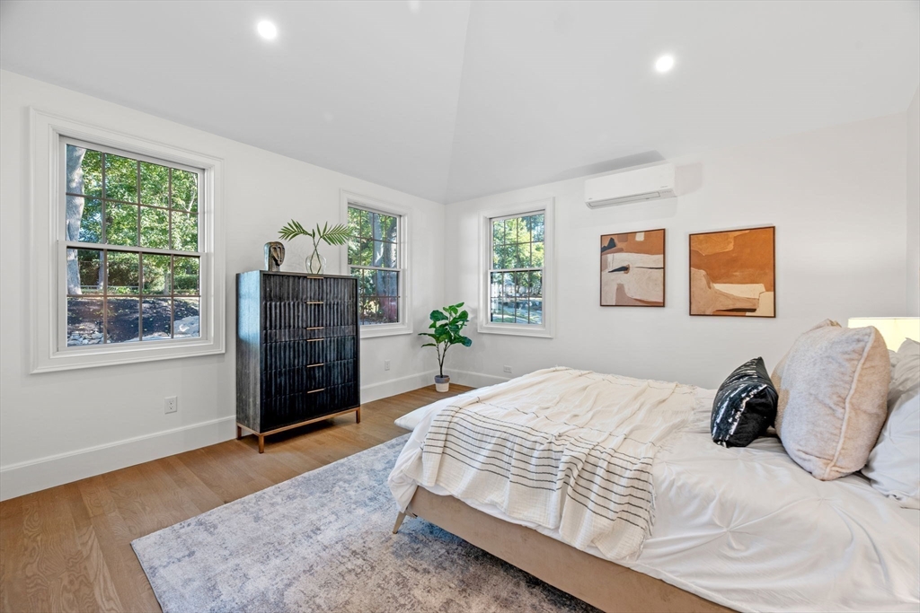 134 Elm Street, Unit 134 Marblehead, MA 01945 - Photo 14 of 38 a bedroom with a bed table and window