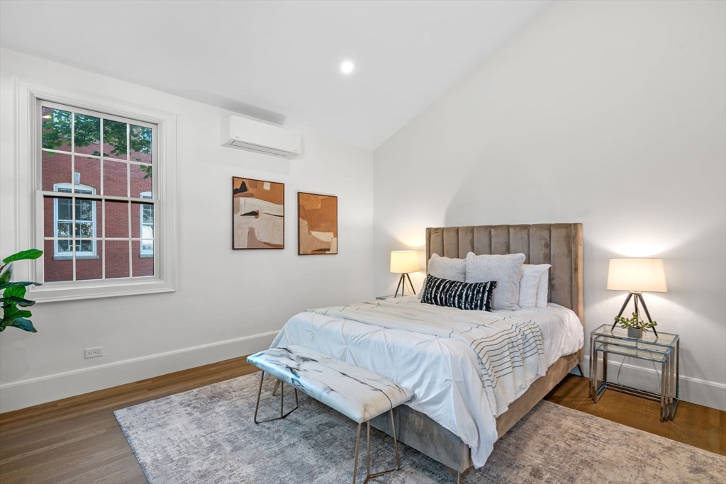 134 Elm Street, Unit 134 Marblehead, MA 01945 - Photo 15 of 38 a bedroom with a bed and wooden floor