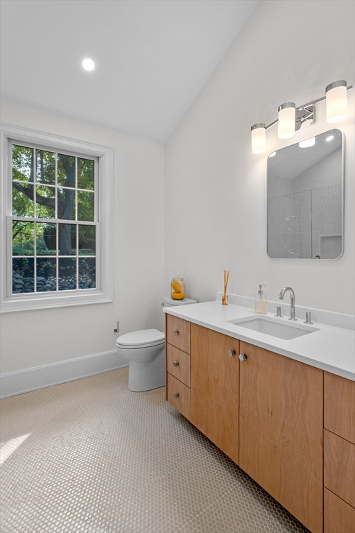134 Elm Street, Unit 134 Marblehead, MA 01945 - Photo 16 of 38 a bathroom with a toilet sink and mirror