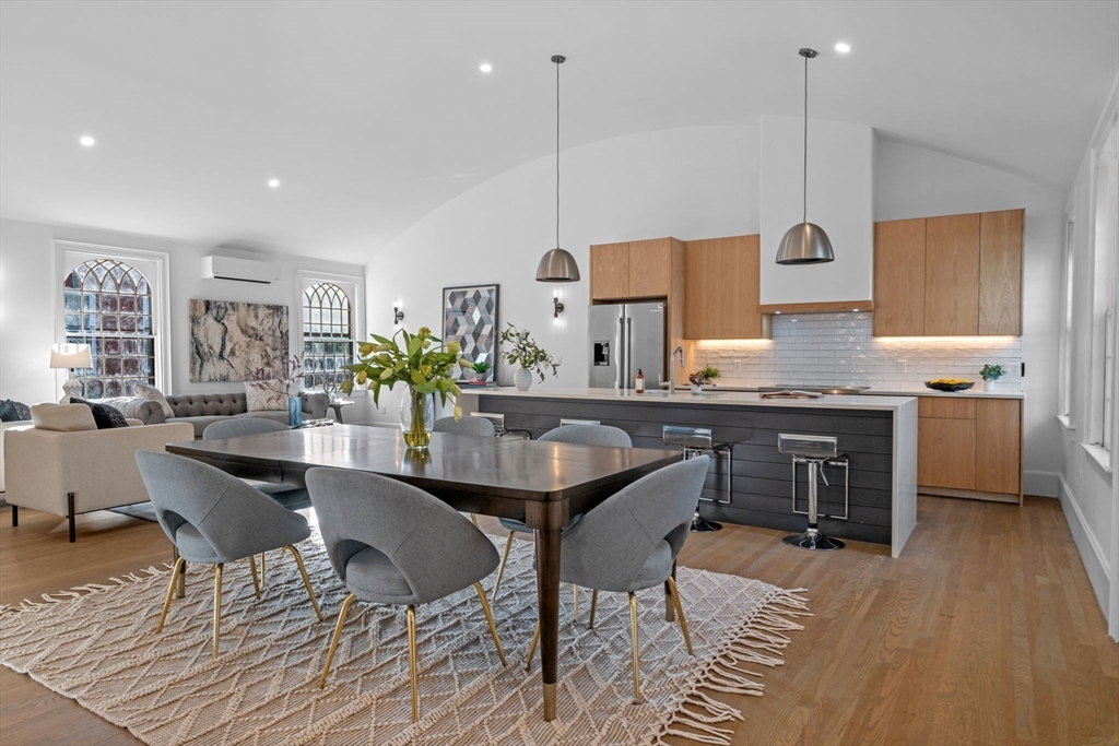 134 Elm Street, Unit 134 Marblehead, MA 01945 - Photo 2 of 38 a kitchen with stainless steel appliances granite countertop a kitchen island a stove and a wooden cabinets