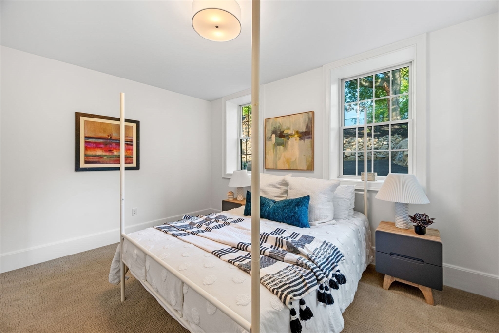 134 Elm Street, Unit 134 Marblehead, MA 01945 - Photo 21 of 38 a bedroom with a bed and wooden floor