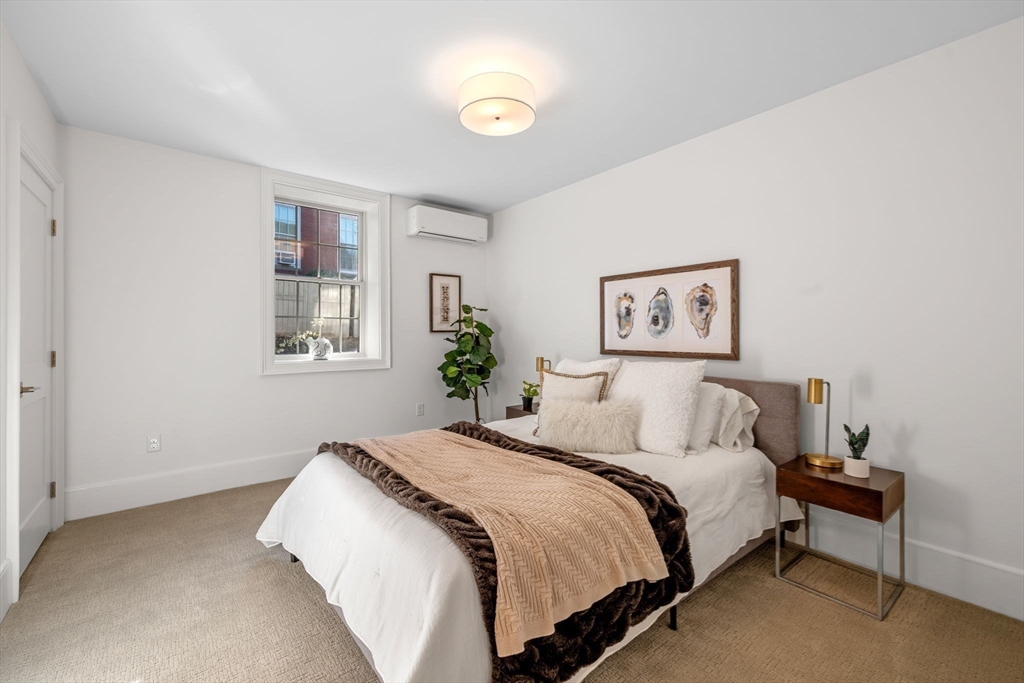 134 Elm Street, Unit 134 Marblehead, MA 01945 - Photo 23 of 38 a bedroom with a bed and a window