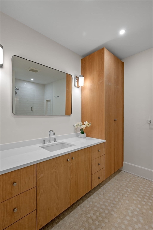 134 Elm Street, Unit 134 Marblehead, MA 01945 - Photo 24 of 38 a bathroom with a sink and a mirror